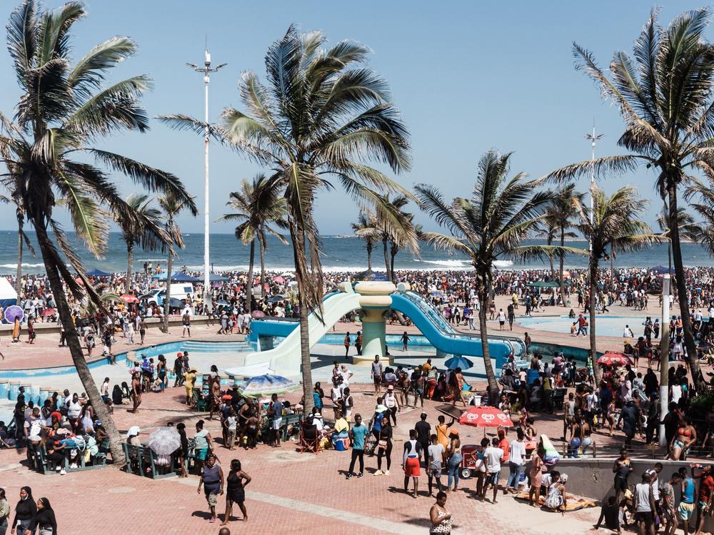Thousands of New Year's day revelers gather on the South Beach in Durban after the government lifted a COVID-19 curfew.