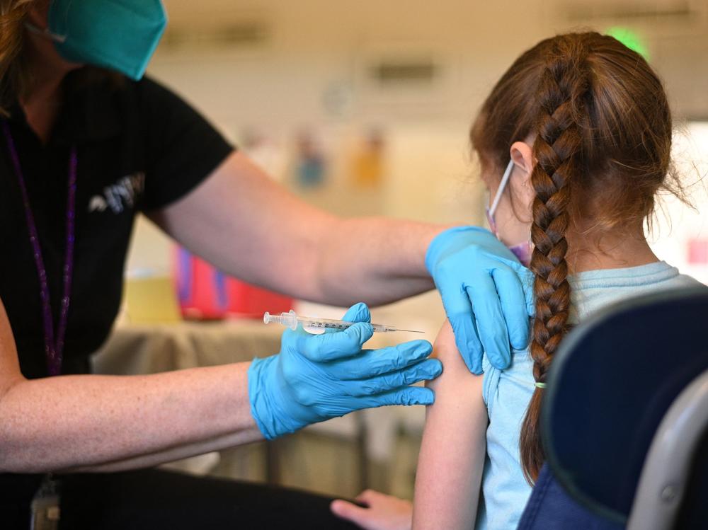 A nurse administers a pediatric dose of the Covid-19 vaccine to a girl at a L.A. Care Health Plan vaccination clinic at Los Angeles Mission College in the Sylmar neighborhood in Los Angeles, Ca., January 19, 2022.