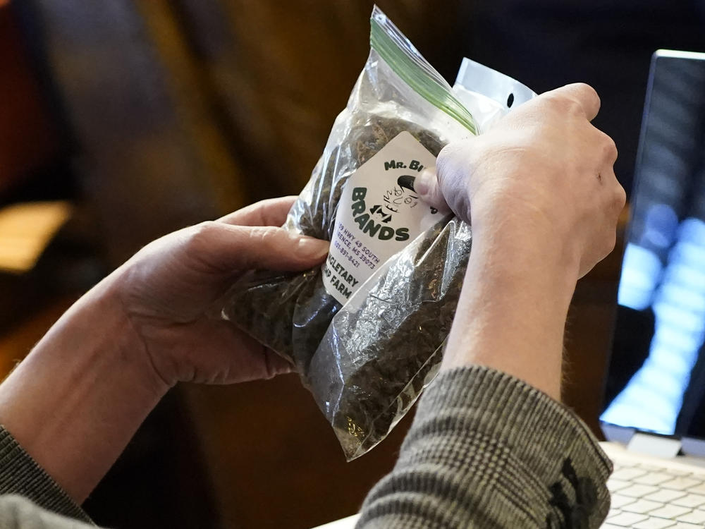 A Mississippi senator holds a bag of hemp product used by Sen. Kevin Blackwell, R-Southaven to illustrate to lawmakers what specific portions of the Mississippi Medical Cannabis Equivalency Units would look like in January.