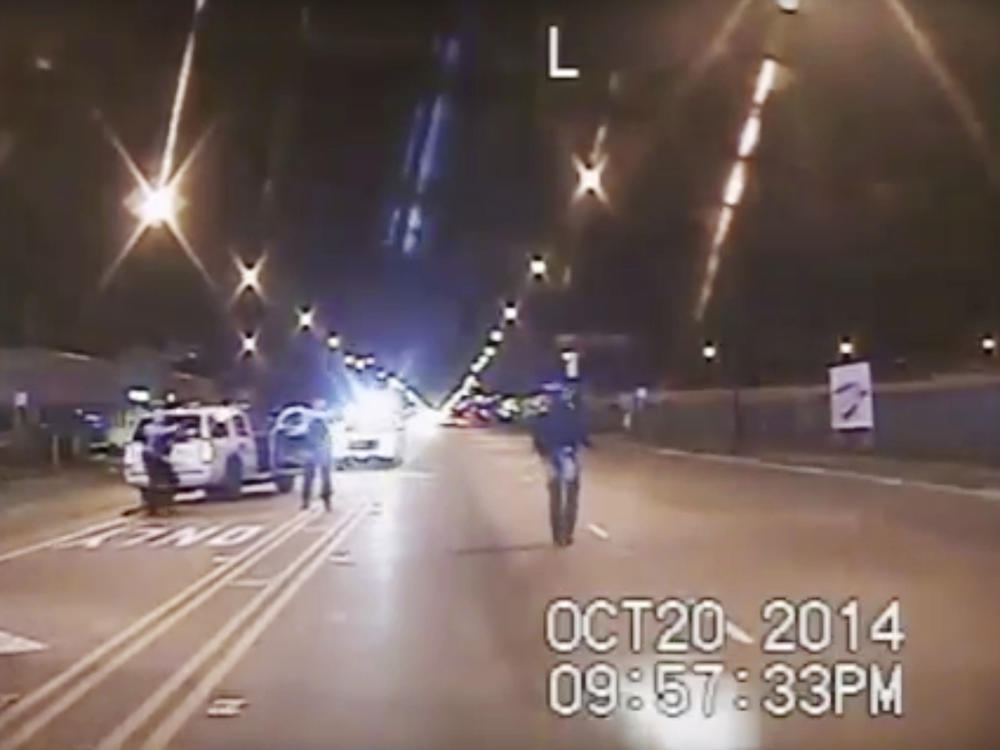 In this Oct. 20, 2014, image made from police dashcam video, Laquan McDonald, 17, right, walks down the street moments before being fatally shot. The images contradicted initial police accounts of the shooting.