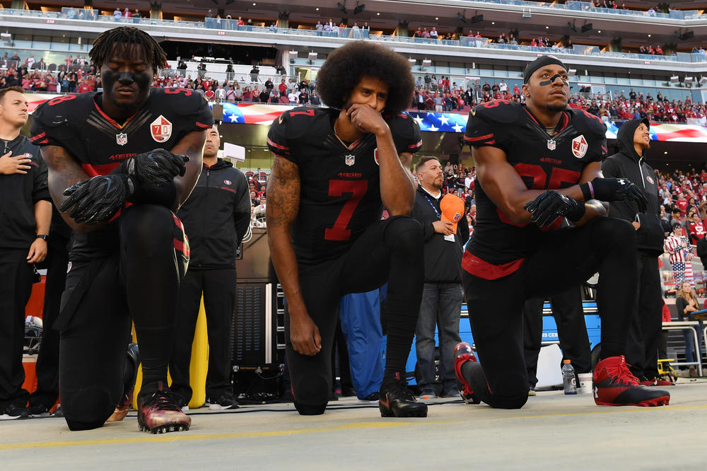 Eli Harold (from left), Colin Kaepernick and Eric Reid of the San Francisco 49ers kneel in protest during the national anthem prior to a game against the Arizona Cardinals at Levi's Stadium on Oct. 6, 2016, in Santa Clara, Calif.