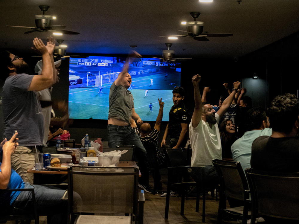 Salvadorans celebrate a late second goal by their national soccer team playing against Honduras as part of the completion to qualify for the 2022 World Cup. El Salvador beat Honduras with a final score of 2-0.