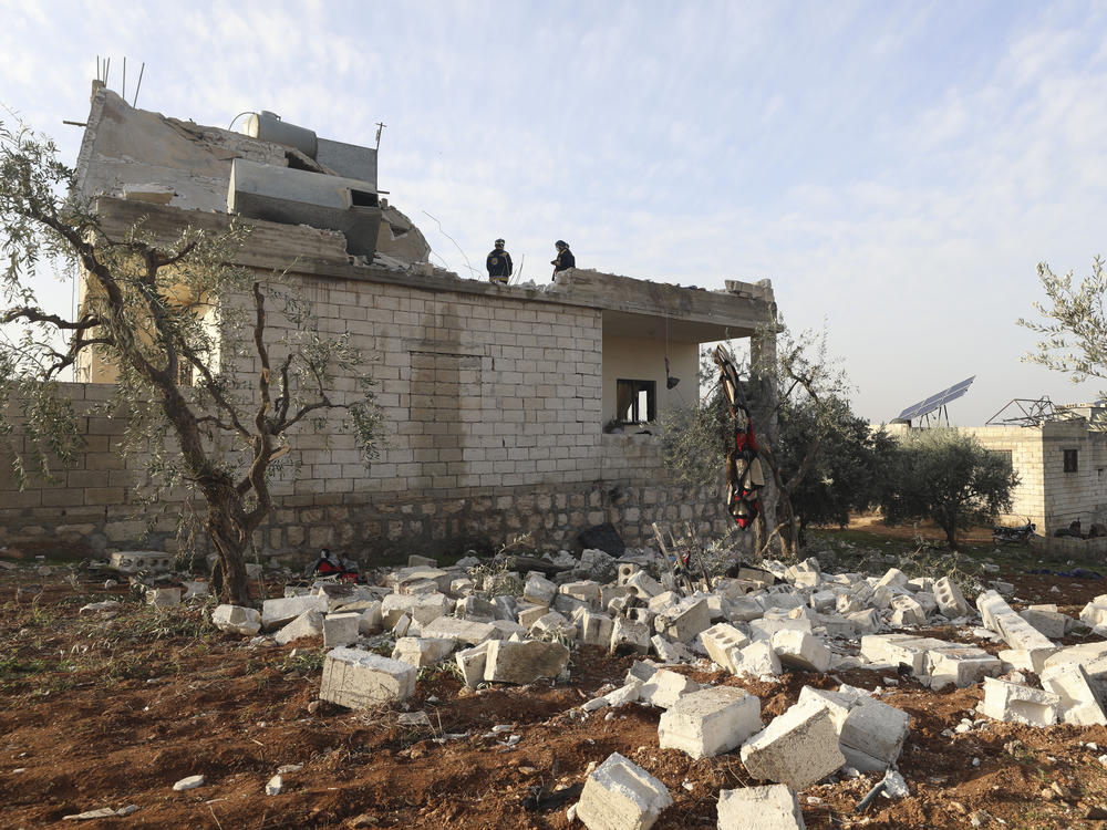 People check a destroyed house after a U.S. military operation in the Syrian village of Atmeh, in Idlib province, on Thursday. U.S. special forces carried out what the Pentagon said was a successful, large-scale counterterrorism raid. Local residents and activists said civilians were also among the dead.