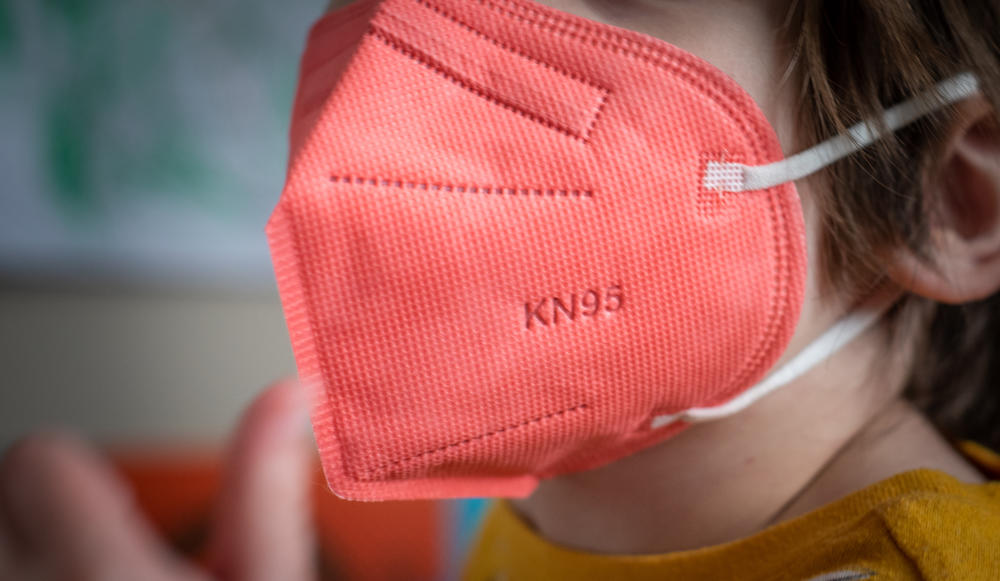 A child wears a KN95 protective mask for kids in Hastings-on-Hudson, New York, U.S., on Thursday, Jan. 13, 2022.