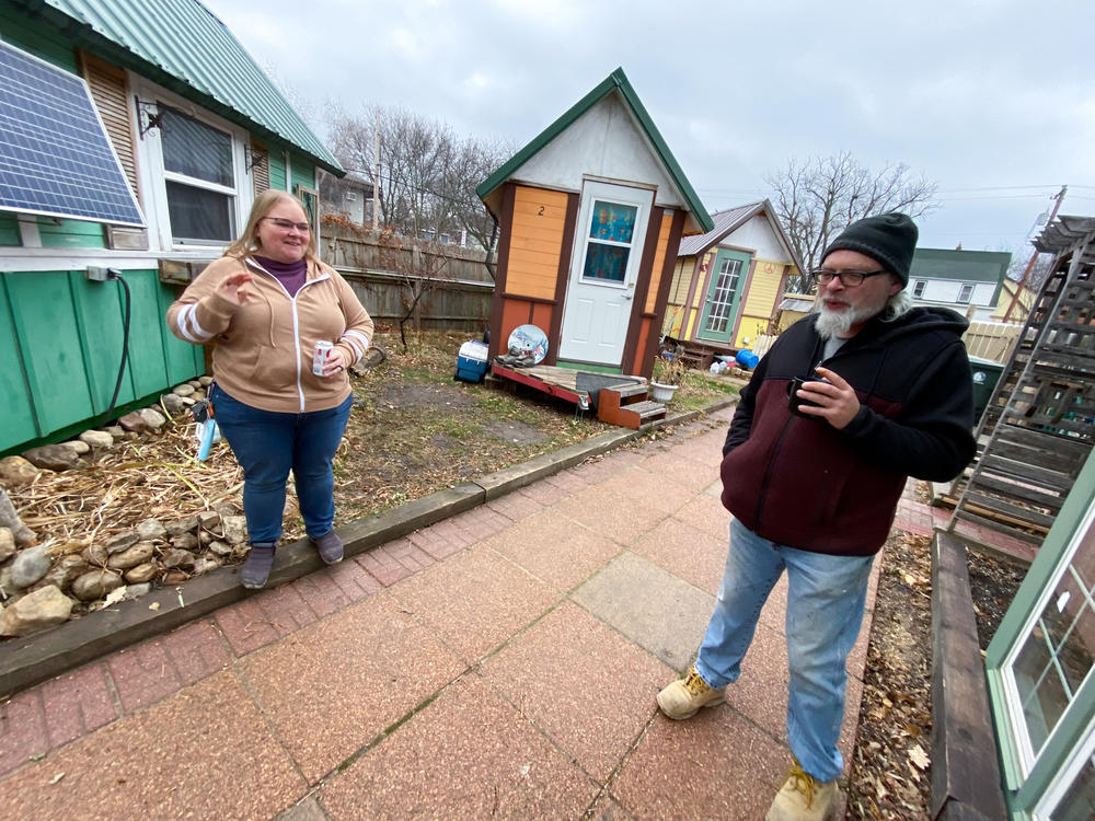 Gene Cox speaks with Brenda Konkel, president of Occupy Madison and executive director of Madison Area Care for the Homeless OneHealth. Occupy Madison provides tiny houses for people experiencing homelessness in Madison, Wisconsin.