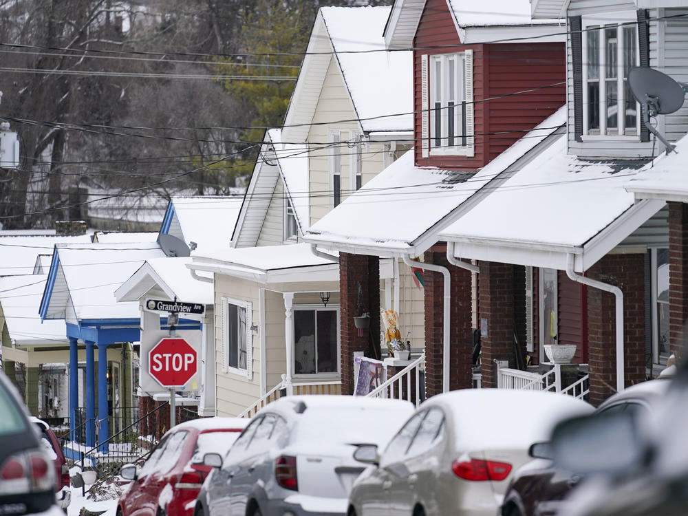Snow blankets a row of homes after a snowstorm in Bellevue, Ky., on Friday.