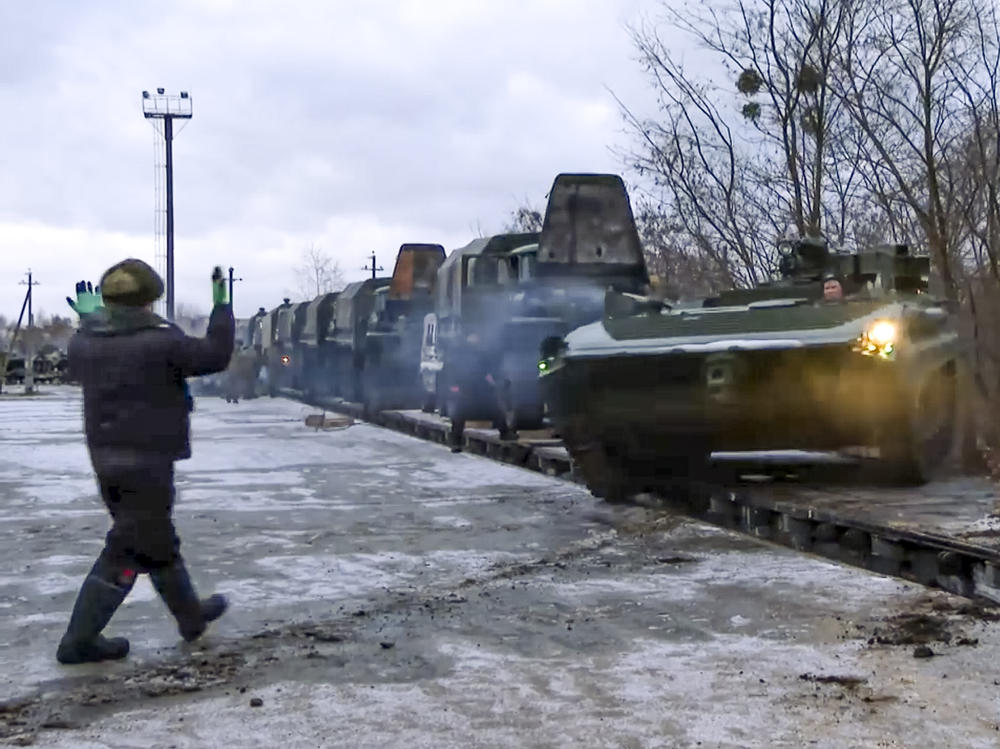 In this photo taken from video provided by the Russian Defense Ministry Press Service, a Russian armored vehicle drives off a railway platform after arrival in Belarus, Jan. 19, 2021. An estimated 100,000 Russian troops near Ukraine has fueled Western fears of an invasion, but Moscow has denied having plans to launch an attack while demanding security guarantees from the the U.S. and its allies.