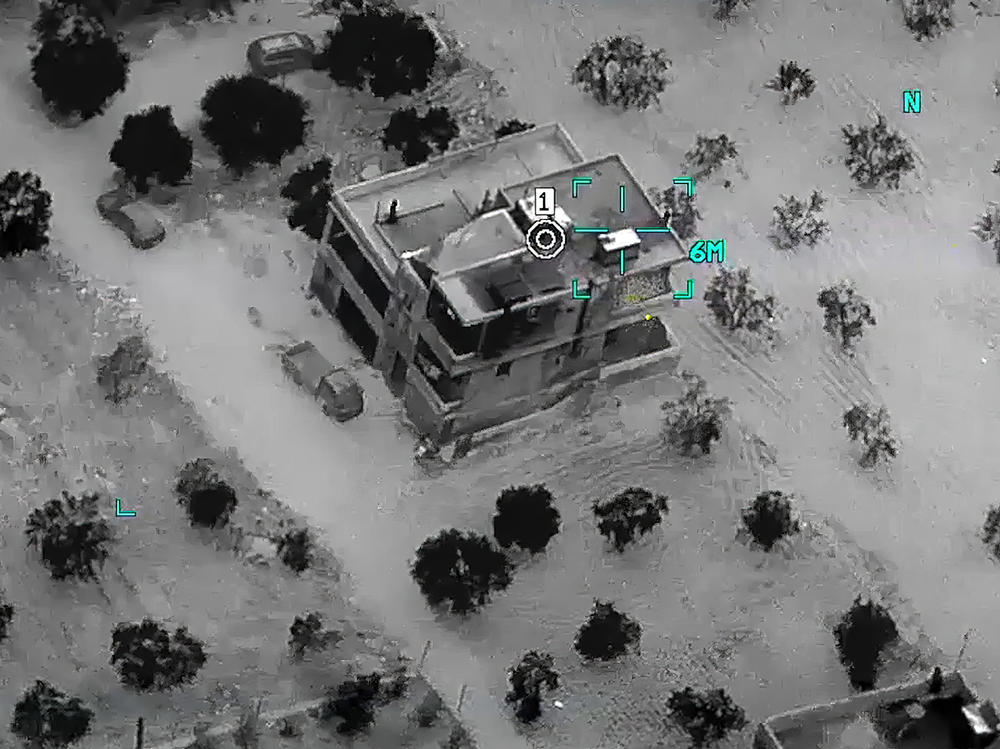 This image from video provided by the Department of Defense and released on Thursday shows the compound where Abu Ibrahim al-Hashimi al-Qurayshi, leader of the Islamic State Group, later died in a raid in Syria's northwestern Idlib province. <em></em>
