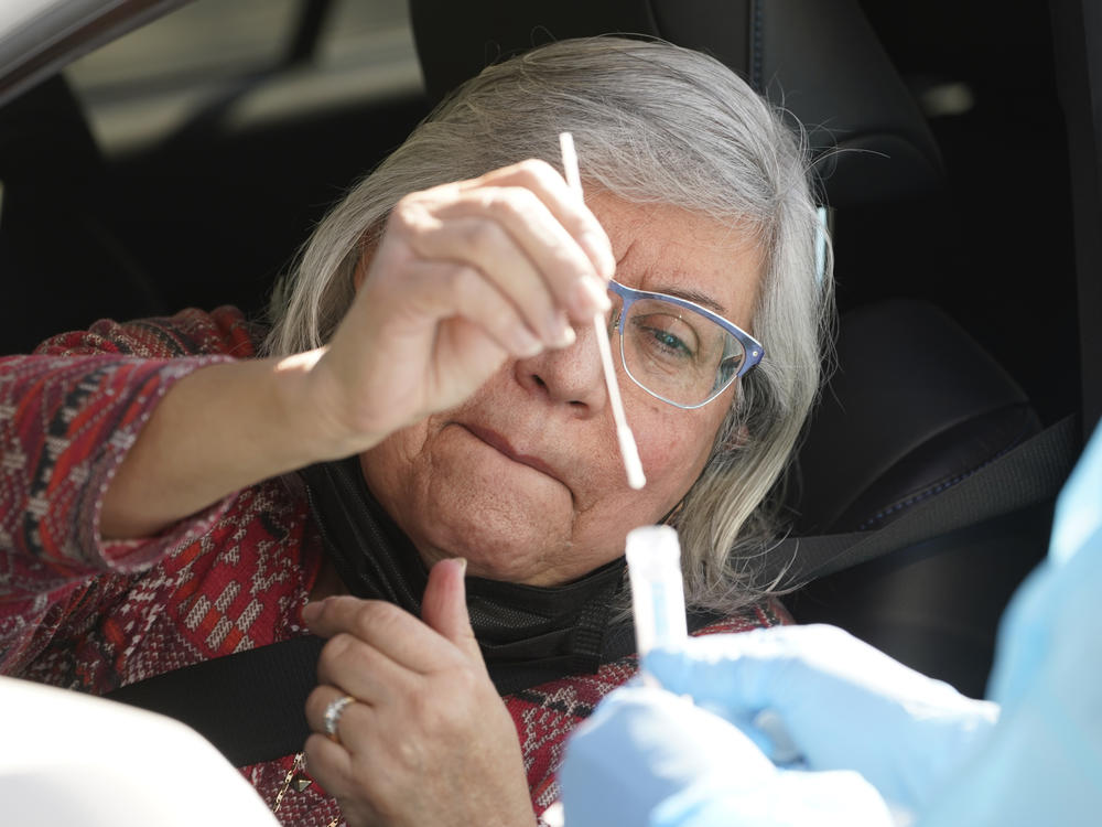 Diana Merchant self-tests for the coronavirus at a drive-through testing site in Whittier, Calif., on Jan. 25. The U.S. passed 900,000 deaths from COVID-19 on Friday.