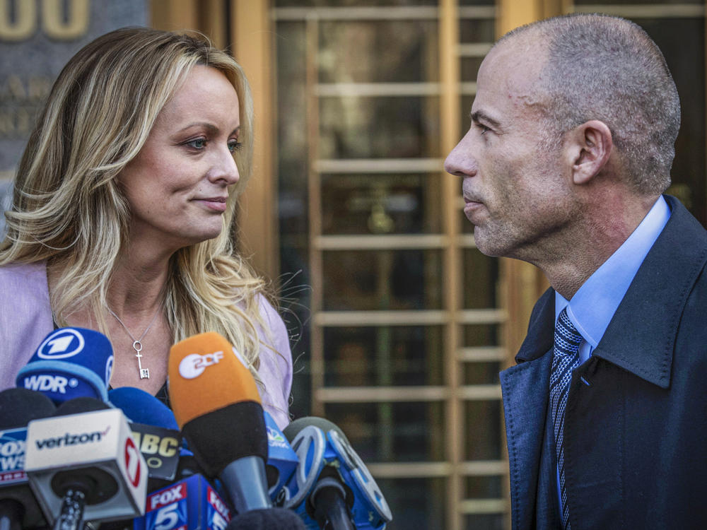 Adult film actress Stormy Daniels stands with her lawyer Michael Avenatti during a news conference outside federal court in New York on April 16, 2018. Avenatti was convicted Friday on charges that he cheated Daniels out of nearly $300,000.