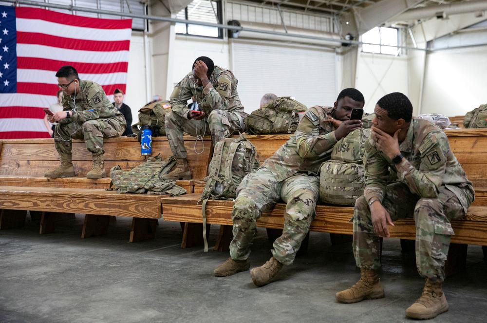 U.S. service members wait at the Pope Army Airfield before deploying to Europe at Fort Bragg, N.C. on Feb. 3.