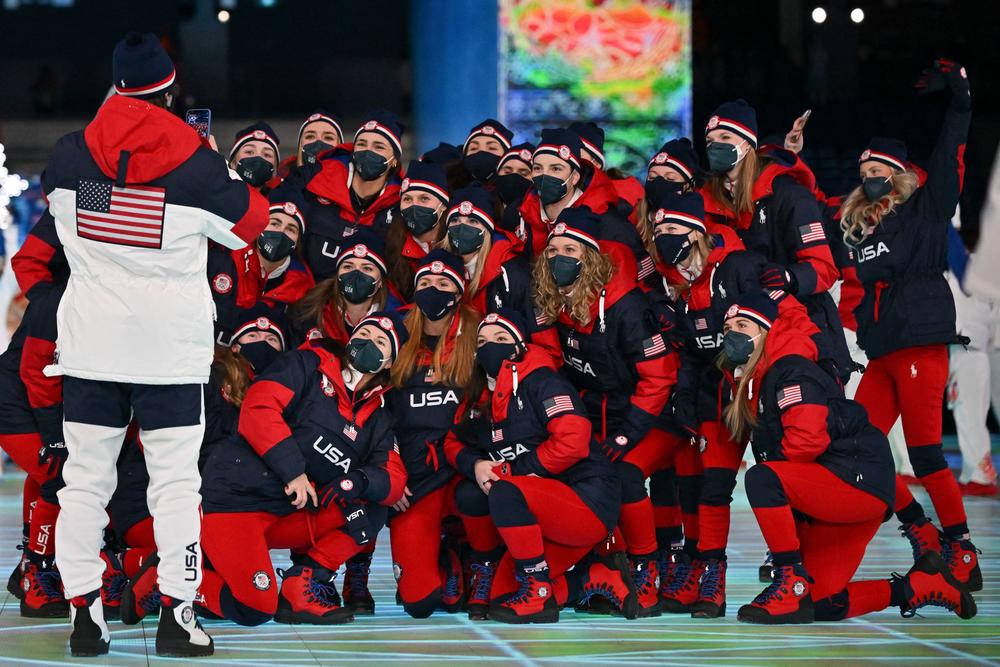 Members of the U.S. delegation pose for photos as they take part in the parade of athletes during the opening ceremony.
