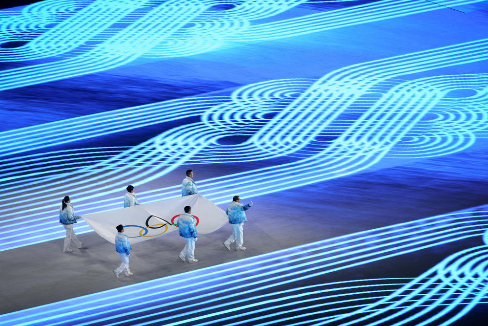 Zhihuan Luo, Hui Zhang, Jiajun Li, Xue Shen, Xiaopeng Han and Hong Zhang carry the Olympic flag during the opening ceremony.