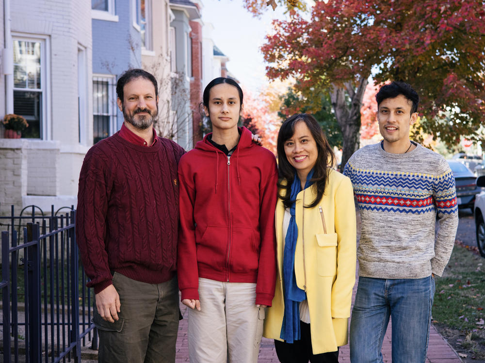 David Roodman and Mai Pham at their Washington, D.C., home with their sons, Alex Roodman (left) and Ben Pham Roodman.