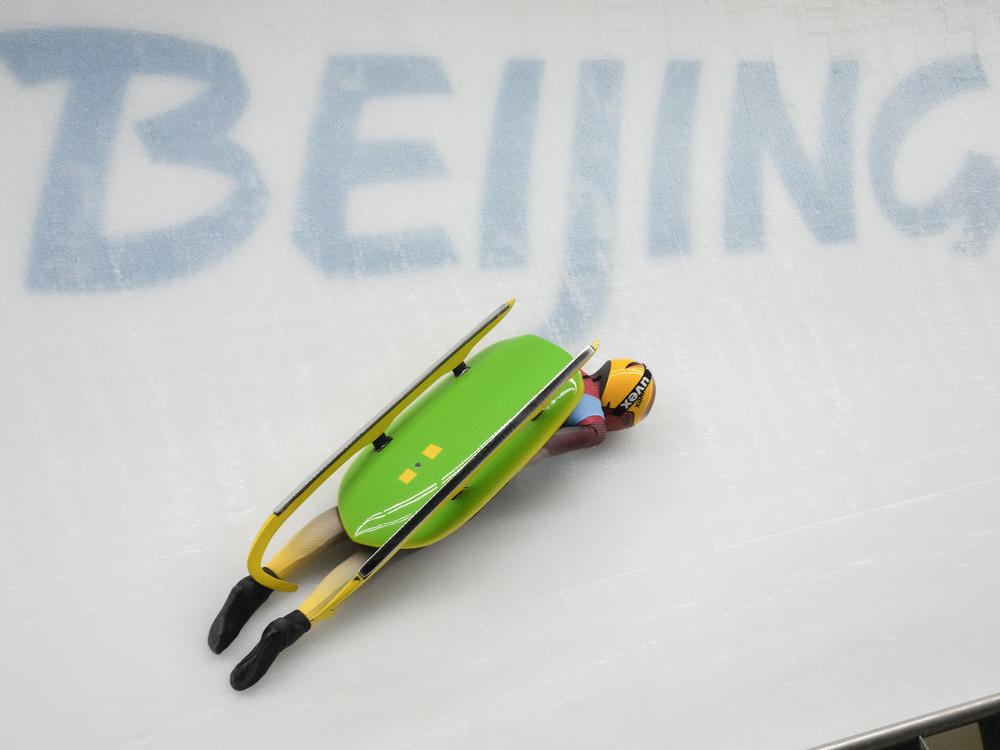 Julia Taubitz, of Germany, crashes during the luge women's singles run 2 at the 2022 Winter Olympics, Monday, Feb. 7, 2022, in the Yanqing district of Beijing.