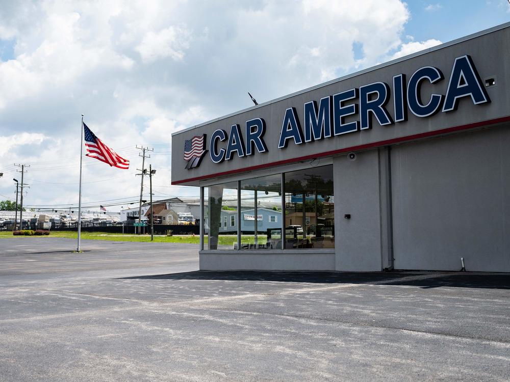 A car dealership stands empty in Laurel, Md., on May 27, 2021, as many car dealerships across the country are running low on new vehicles because of a computer chip shortage. It's months later, and automakers are still struggling to meet demand.