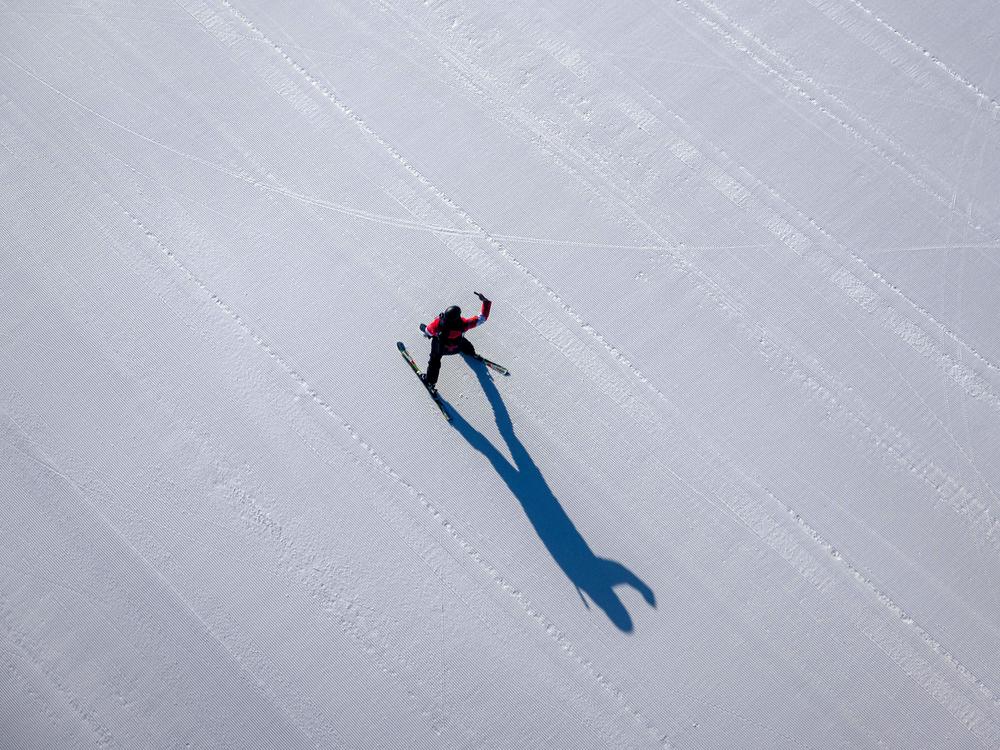 A skier takes a selfie on a course covered with artificial snow at the Yanqing National Alpine Skiing Centre in Yanqing.