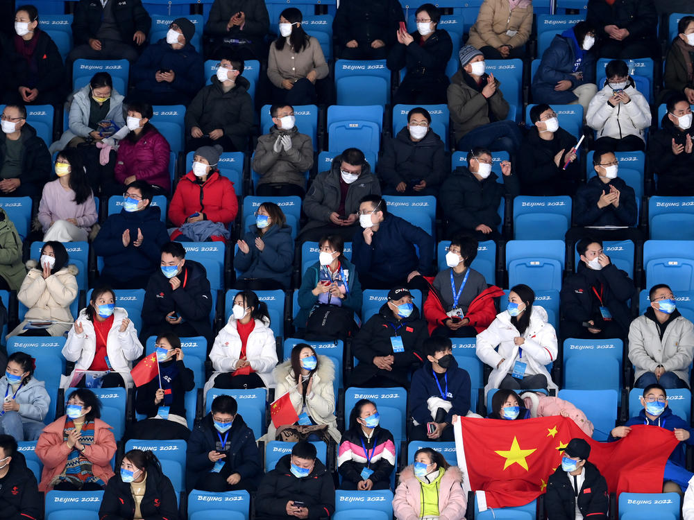 Spectators watch the men's single skating short program on Tuesday at the Winter Olympics in Beijing.