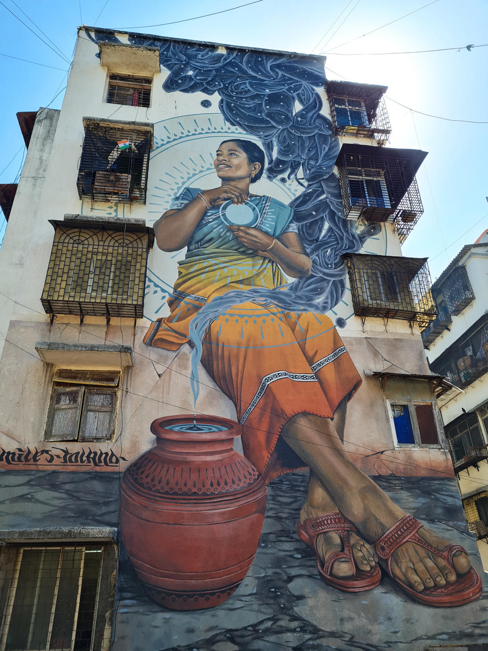 Murals on the sides of buildings near Dharavi, Mumbai's biggest slum, where social workers hold workshops to educate women about sexual violence and consent.