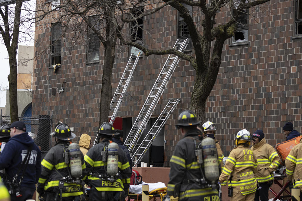 Ladders are erected beside the apartment building where a fire occurred in the Bronx in New York City last month, killing 17 people and injuring dozens.