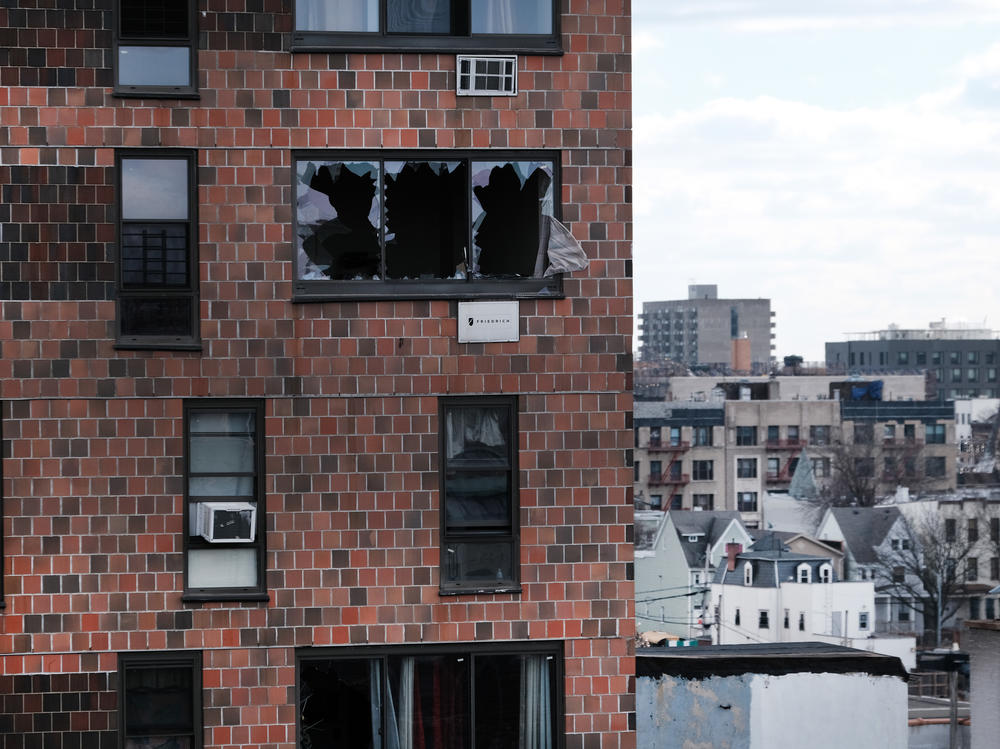 The Bronx apartment building stands a day after a fire swept through the complex where 8 of the 17 people who died were children.