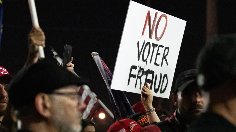 A Trump supporter holds up a 