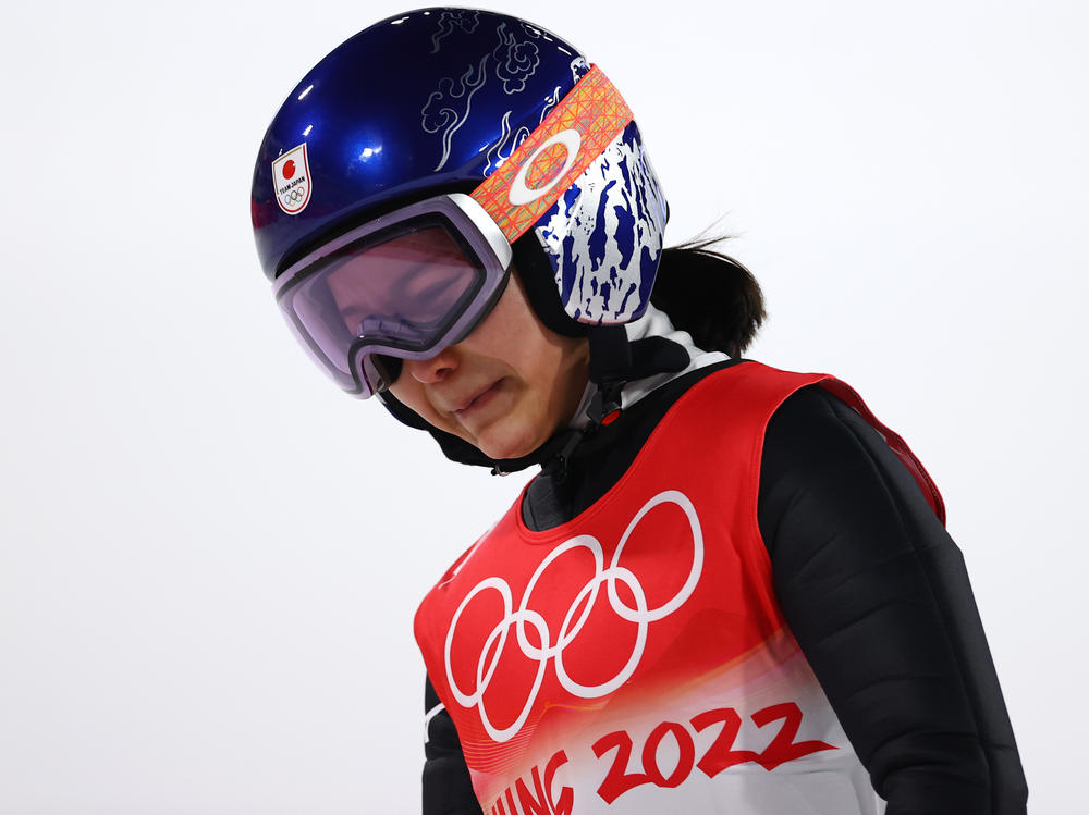 Sara Takanashi of Team Japan shows dejection after being disqualified after jumping in the final round of the mixed-team ski jumping event at the National Ski Jumping Center in Zhangjiakou, China.
