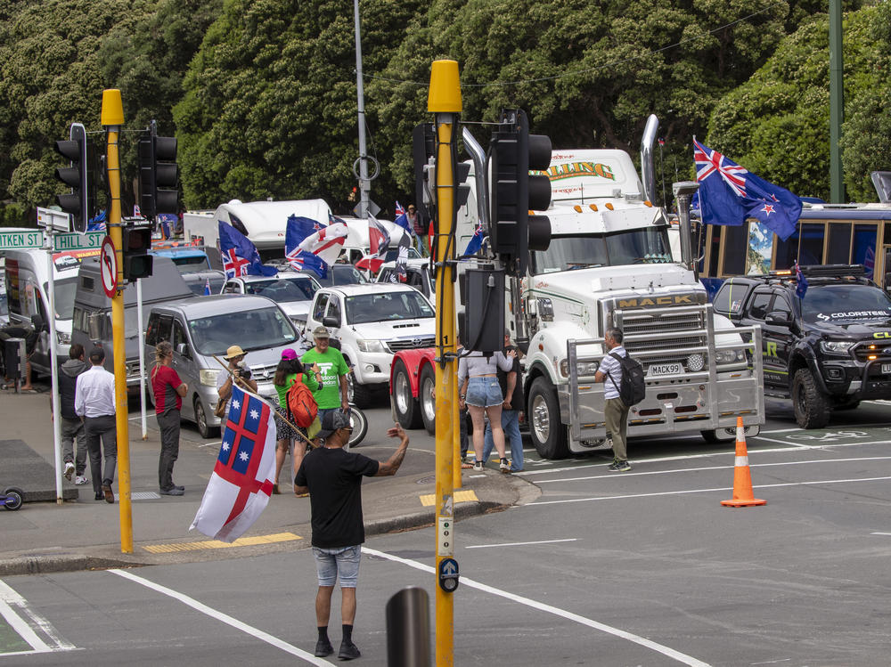 A convoy of vehicles block an intersection near New Zealand's Parliament in Wellington on Tuesday. Hundreds of people protesting vaccine and mask mandates drove in convoy to New Zealand's capital and converged outside Parliament as lawmakers reconvened after a summer break.