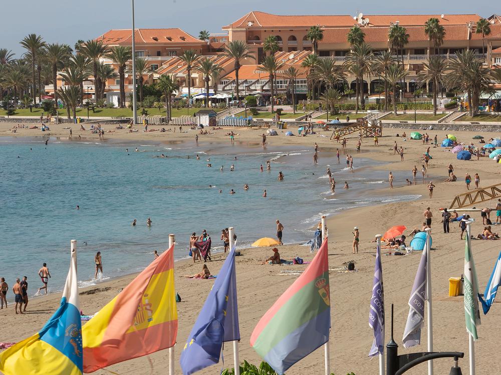 Tourists enjoy a day at the beach on the Canary Island of Tenerife. A Welsh recruitment company is treating its entire staff to a vacation on the island.