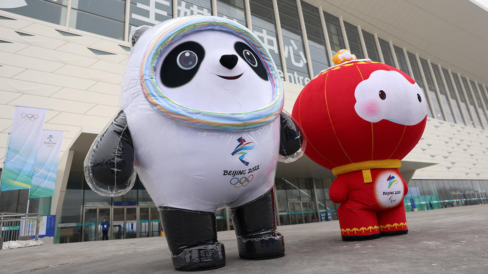 Staff members dressed up as Beijing 2022 Winter Olympics mascot Bing Dwen Dwen (left) and 2022 Paralympics mascot Shuey Rhon Rhon stand in front of the Main Media Center last month in Beijing.