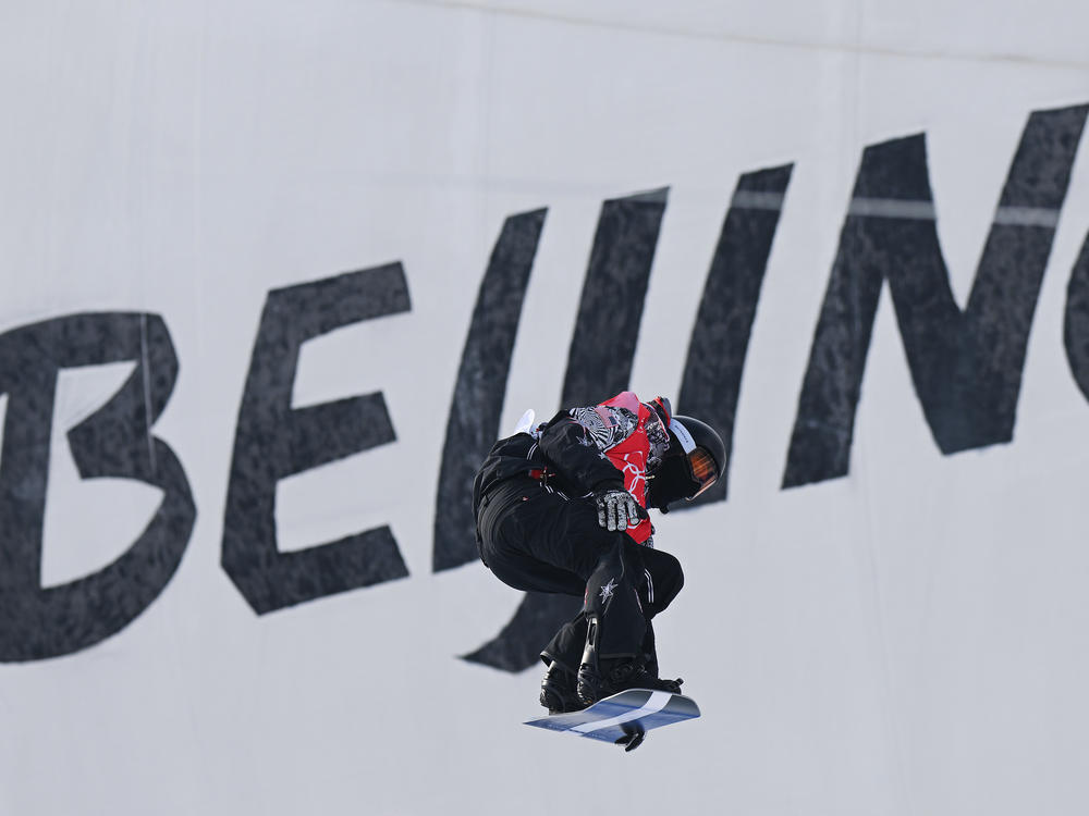 Shaun White performs a trick during the men's snowboard halfpipe qualification.
