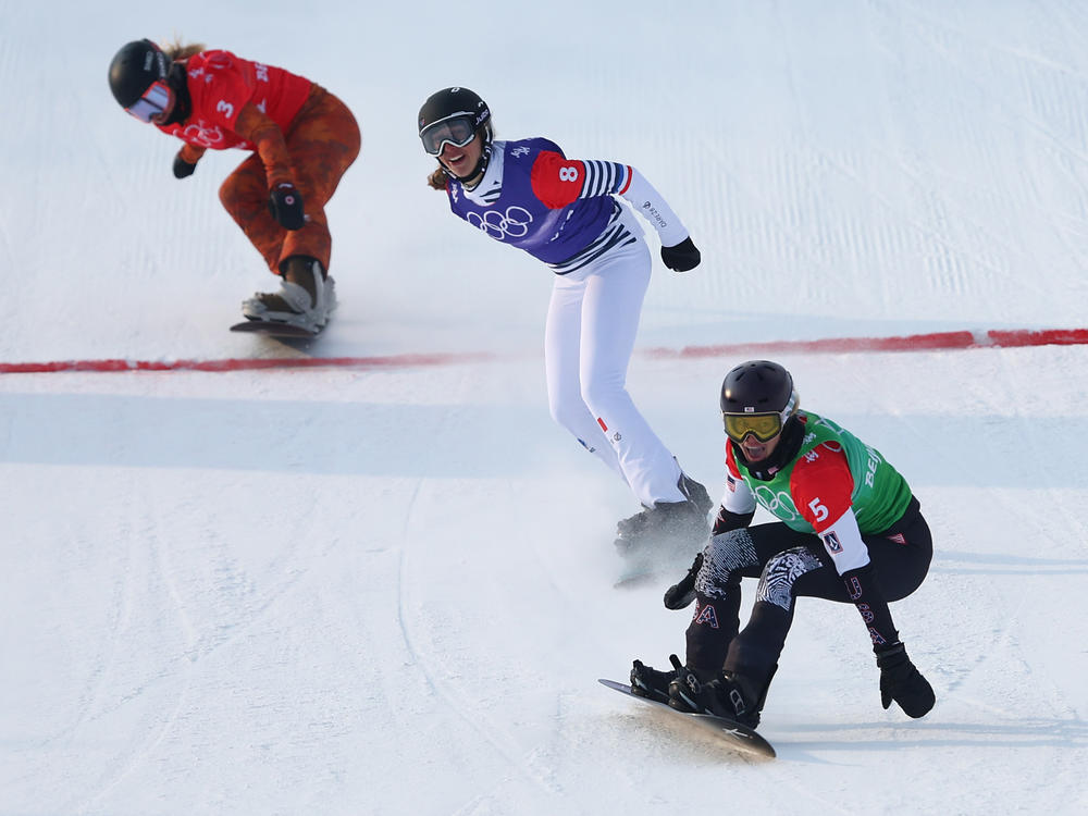 Jacobellis reacts after crossing the finish line to win the gold medal during the women's snowboard cross big final at the Beijing 2022 Winter Olympic Games.