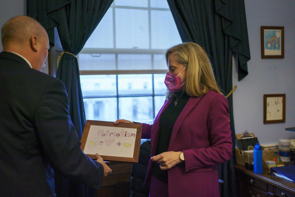 Spanberger shows Roy a framed picture in her office. Both lawmakers bemoan that in the current political environment there is a tendency to avoid signing onto bills without 100% agreement on every detail.