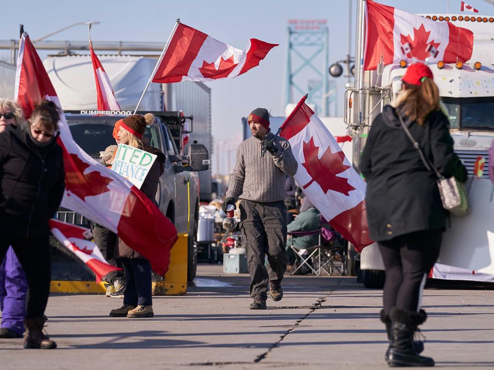 The escalating protests against COVID-19 vaccine mandates in Canada block the roadway at the Ambassador Bridge border crossing in Windsor, Ontario.