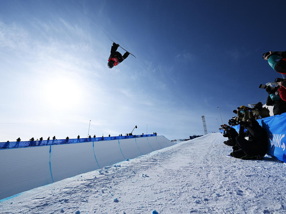 Shaun White of Team USA performs a trick during the men's snowboard halfpipe final at the 2022 Winter Olympics.