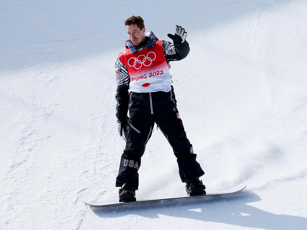 Shaun White of Team USA waves goodbye after his final run in the men's snowboard halfpipe final at the 2022 Winter Olympics in Beijing. He placed fourth in his final race.