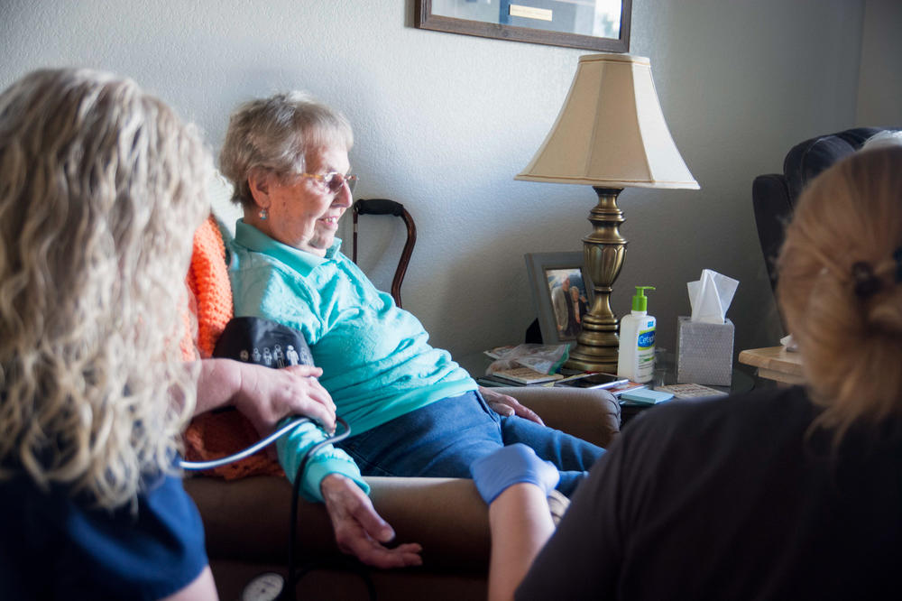 DispatchHealth nurses check Dolores Wiese's vital signs during a hospital-at-home visit on January 3, 2022.