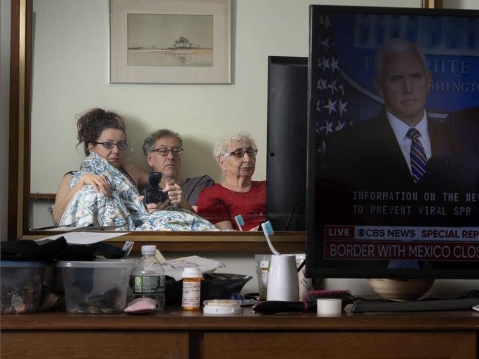 Sophia Lansky, Neil Kramer and Kramer's mother, Elaine, watch the news in March 2020, from their two-bedroom apartment in Queens.