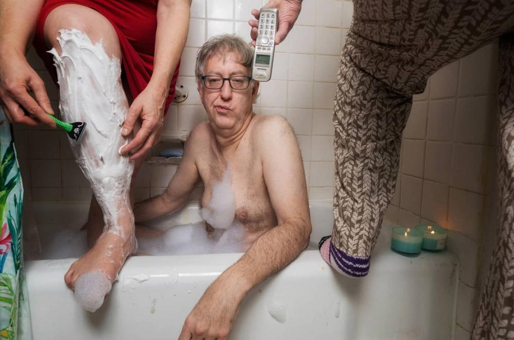 Sophia Lansky, Neil Kramer and Kramer's mother Elaine, crowd into their bathroom in Queens in April 2020 in a staged scene as part of photography project by Kramer.