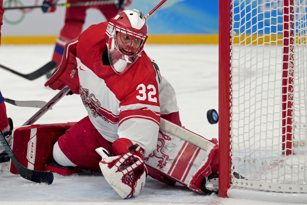 Denmark goalkeeper Sebastian Dahm (32) reaches for a shot that bounces off the post during a preliminary round men's hockey game against Czech Republic at the 2022 Winter Olympics, Wednesday, Feb. 9, 2022, in Beijing.