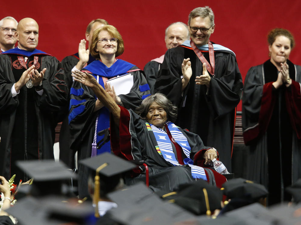 Autherine Lucy Foster (center), the first black student to attend the University of Alabama, waves as the university awarded her an honorary doctorate during a commencement ceremony, on May 3, 2019, in Tuscaloosa, Ala.
