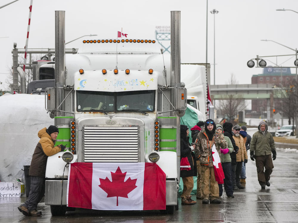 Truckers and supporters block the access leading from the Ambassador Bridge linking Detroit, Mich., and Ontario as they continue to protest against COVID-19 vaccine mandates and restrictions on Friday.