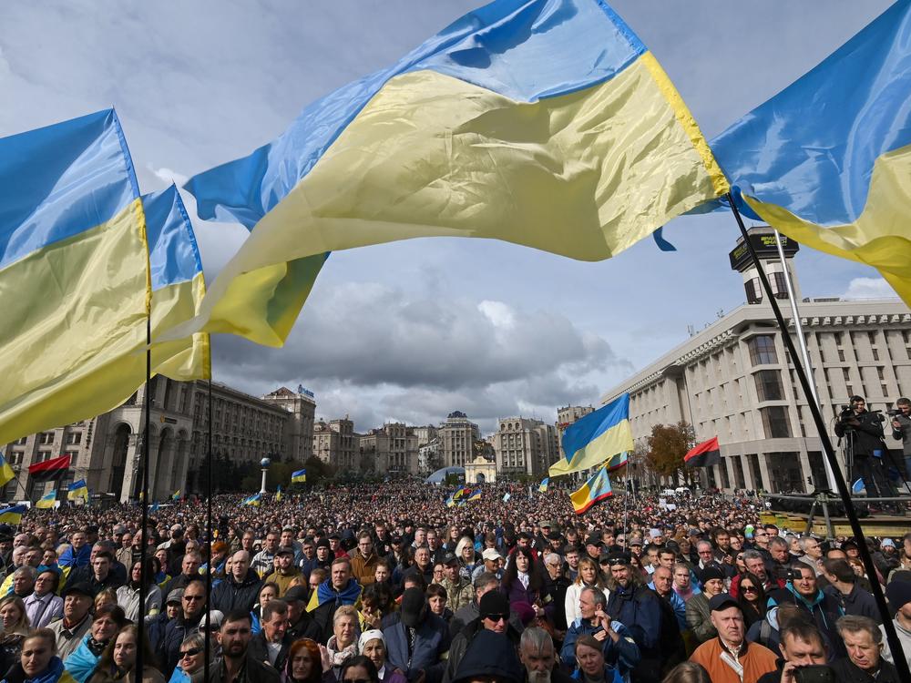 Demonstrators wave Ukraine national flags as they gather in central Kyiv on Oct. 6, 2019, to protest broader autonomy for separatist territories, part of a plan to end a war with Russian-backed fighters. Protesters chanted 