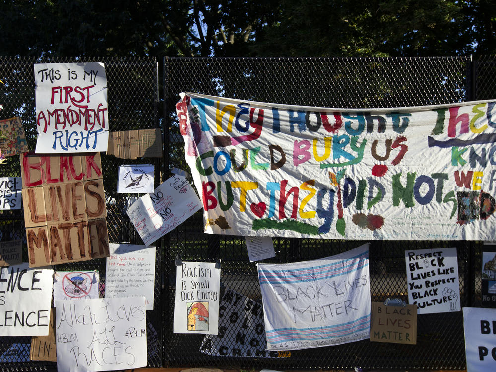 Banners and signs are hung on a fence at Lafayette Square near the White House, during ongoing protests against police brutality and racism in June 2020. The Library of Congress has digitized some of the pieces of artwork, signs and photographs once displayed on the fence.