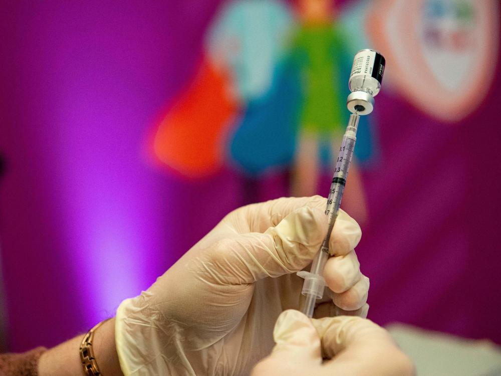 A medical worker prepares the Pfizer-BioNTech Covid-19 vaccine booster in Hartford, Connecticut, in January.