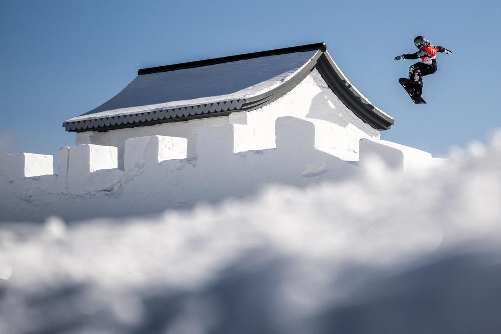 An athlete takes part in a snowboard slopestyle practice session at Genting Snow Park in Zhangjiakou on February 3, 2022, ahead of the Beijing 2022 Winter Olympic Games.