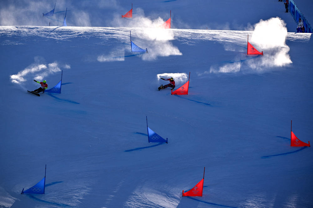 Austria's Benjamin Karl (R) and Slovenia's Tim Mastnak compete in the snowboard men's parallel giant slalom final during the Beijing 2022 Winter Olympic Games at the Genting Snow Park P & X Stadium in Zhangjiakou on February 8, 2022.