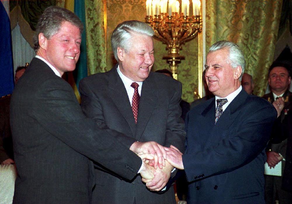 President Bill Clinton (from left), Russian President Boris Yeltsin and Ukrainian President Leonid Kravchuk join hands On Jan. 14, 1994, after signing a nuclear disarmament agreement in the Kremlin. Under the agreement Ukraine, the world's third-largest nuclear power, said it would turn all of its strategic nuclear arms over to Russia for destruction.