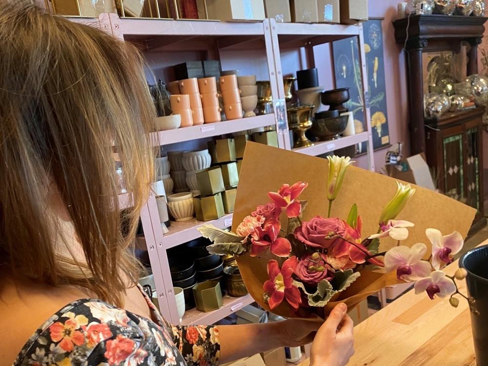 Holley Simmons, owner of the flower shop She Loves Me based in Washington, D.C., displays the grocery store-bought bouquet.