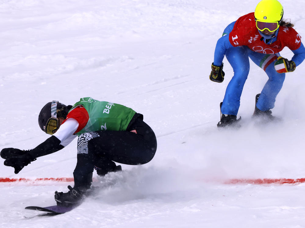 U.S. snowboarder Lindsey Jacobellis competes against Italy's Michela Moioli during the 2022 Beijing Olympic Games.